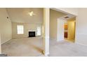 Spacious living room with fireplace and carpet flooring throughout the home at 5502 Sapphire Cir, Ellenwood, GA 30294