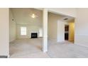 Expansive open-concept living room featuring a fireplace and neutral carpeting at 5502 Sapphire Cir, Ellenwood, GA 30294