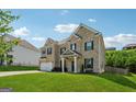 Well-kept two-story home featuring a brick facade, landscaped yard, and a two-car garage, set against a clear sky at 3711 Wartrace Dr, South Fulton, GA 30331