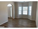 Bright living room with light walls, new wood-look flooring, and large bay windows at 1238 Polk Xing, Mcdonough, GA 30252