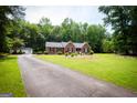 Inviting home with a long driveway and spacious front yard at 155 Granby Ln, Fayetteville, GA 30215