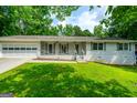 Traditional home with attached garage, shutters, and a cozy front porch at 120 Lakeside Dr, Ellenwood, GA 30294