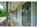 Welcoming front porch features gray trim, a decorative wreath and convenient overhead lighting at 120 Lakeside Dr, Ellenwood, GA 30294