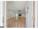 Inviting living room showcasing hardwood floors, a stone fireplace, and neutral paint at 120 Lakeside Dr, Ellenwood, GA 30294