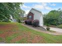 Well-maintained home with brick and siding, features a lush yard and driveway at 634 Skyline Dr, Villa Rica, GA 30180