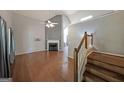 Open living room featuring hardwood floors, fireplace, and staircase at 634 Skyline Dr, Villa Rica, GA 30180