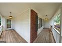 Inviting covered porch featuring wood flooring and decorative lighting fixtures at 634 Skyline Dr, Villa Rica, GA 30180