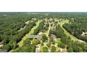 Aerial view of wooded neighborhood, showing home's location in a lush, green setting at 595 Mcgarity Dr, Mcdonough, GA 30252