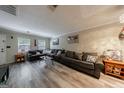 Spacious living room with hardwood floors, large comfortable sofa, and lots of natural light at 105 N River Dr # G, Sandy Springs, GA 30350