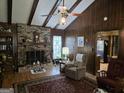 Charming living room showcasing a brick fireplace, hardwood floors, and a comfortable reading nook by the window at 529 Valley Woods Se Cir, Conyers, GA 30094