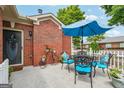 Inviting outdoor patio with a table, four chairs, and blue umbrella for relaxation at 119 Holiday Road, Unit 301 Rd # 301, Buford, GA 30518