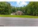 Stately brick two-story home boasts mature trees, a manicured lawn, and a three-car garage at 307 Bellingrath Ct, Peachtree City, GA 30269