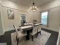 Bright dining room featuring a modern chandelier and an elegant table setting at 1012 Institute Nw St, Conyers, GA 30012