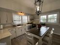 Cozy kitchen featuring white cabinets, modern appliances, and a kitchen island at 1012 Institute Nw St, Conyers, GA 30012