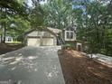 Exterior view of house featuring a two car garage and lovely front yard at 2532 N Carroll Ct, Villa Rica, GA 30180