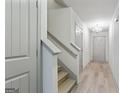 Inviting hallway with hardwood floors, staircase, and modern lighting fixtures at 2714 Haynescrest Dr, Grayson, GA 30017