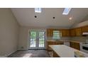 Cozy kitchen with a view of the deck, featuring ample countertop space and classic cabinetry at 9230 Melody Sw Cir, Covington, GA 30014