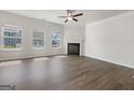 Bright living room with hardwood floors, a fireplace, and multiple windows for plenty of natural light at 36 Crescent Chase, Dallas, GA 30157