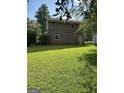Large backyard with lush green lawn, perfect for relaxation or entertaining, also features chain link fence at 90 Cabriolet Trail, Mcdonough, GA 30253