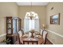 Elegant dining room with a chandelier, large window, and seating for six at 1335 Vine Cir, Mcdonough, GA 30253