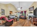 Spacious living room featuring a fireplace, vaulted ceilings, and hardwood floors at 1335 Vine Cir, Mcdonough, GA 30253