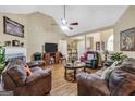 Comfortable living room with a fireplace, ceiling fan, and ample seating at 1335 Vine Cir, Mcdonough, GA 30253
