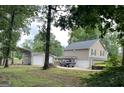 Large lot with detached two car garage and metal carport on this spacious two-story home's rear exterior at 565 Scarborough Rd, Ellenwood, GA 30294