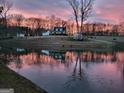 Picturesque country home reflected in a serene pond at sunset at 251 Merrell Rd, Carrollton, GA 30116