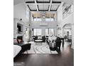 An elegant open-plan living room featuring high ceilings, a fireplace, and exquisite finishes at 50 Birch Road, Covington, GA 30014