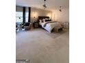 Spacious main bedroom featuring neutral decor, decorative lighting, and a cozy sitting area at 125 Sir Lancelot Ct, Fayetteville, GA 30214
