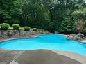 Beautiful in-ground pool surrounded by lush greenery, creating a private oasis at 125 Sir Lancelot Ct, Fayetteville, GA 30214