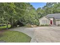 A charming home with lush landscaping, a spacious driveway, and inviting curb appeal at 118 Whitfield Run, Peachtree City, GA 30269