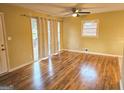Bright living room featuring hardwood floors, large windows, and a ceiling fan at 655 Shellnut Dr, Forest Park, GA 30297