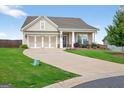 Inviting single-story home featuring a three-car garage, a well-maintained lawn and attractive landscaping at 4160 Grandview Vista St, Cumming, GA 30028