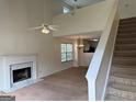 Bright living room featuring a fireplace, high ceilings, and staircase to the second level at 133 Magazine St, Dallas, GA 30157