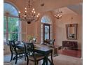 Formal dining room featuring elegant chandeliers, large windows, and sophisticated decor, creating a refined ambiance at 183 Eagles Club Dr, Stockbridge, GA 30281