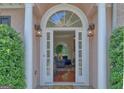Inviting front entrance with decorative glass, sidelights, and elegant columns, opening to a bright interior at 183 Eagles Club Dr, Stockbridge, GA 30281