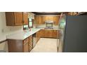 Well-lit kitchen featuring stainless steel appliances, light countertops, wooden cabinetry, and a window at 3626 Lone Indian Trl, Marietta, GA 30066