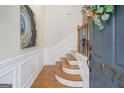 Bright entry foyer with hardwood floors and paneled walls at 10775 Brunson Dr, Johns Creek, GA 30097