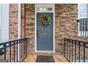 Inviting front door with stone surround and decorative wreath at 10775 Brunson Dr, Johns Creek, GA 30097