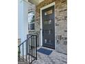 Modern black front door with horizontal window panes, brick walkway, and contemporary exterior lighting at 4107 Township Pkwy # 69, Sandy Springs, GA 30342