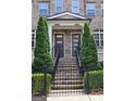Inviting front entrance with twin address numbers, featuring a brick stairway, metal railings, and manicured greenery at 4107 Township Pkwy # 69, Sandy Springs, GA 30342