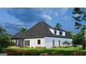 Exterior view of a lovely white brick home featuring a covered porch and a lush, green backyard with flowers at 1077 Crooked Creek Rd, Lithonia, GA 30058