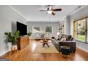 Cozy living room with hardwood floors, a ceiling fan, built-in shelving, and comfortable seating at 792 Mimosa Se Dr, Marietta, GA 30060