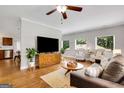Spacious living room featuring hardwood floors, a ceiling fan, and large windows for natural light at 792 Mimosa Se Dr, Marietta, GA 30060