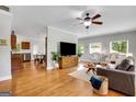 Bright living room featuring hardwood floors, a ceiling fan, and large windows for natural light at 792 Mimosa Se Dr, Marietta, GA 30060