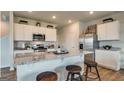 Modern kitchen featuring stainless steel appliances, granite countertops, and a breakfast bar with seating at 11899 Aukerman Way, Hampton, GA 30228