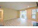 Bright living room featuring light-colored floors, sliding glass doors to a balcony, and a window letting in natural light at 1102 Wynnes Ridge Cir, Marietta, GA 30067