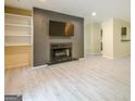 Open-concept living area with fireplace, built-in shelving, and a peek into the kitchen area at 1102 Wynnes Ridge Cir, Marietta, GA 30067