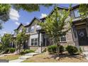 Attractive townhomes with brick and siding, landscaping and inviting entrances at 1004 Bayrose Cir, East Point, GA 30344